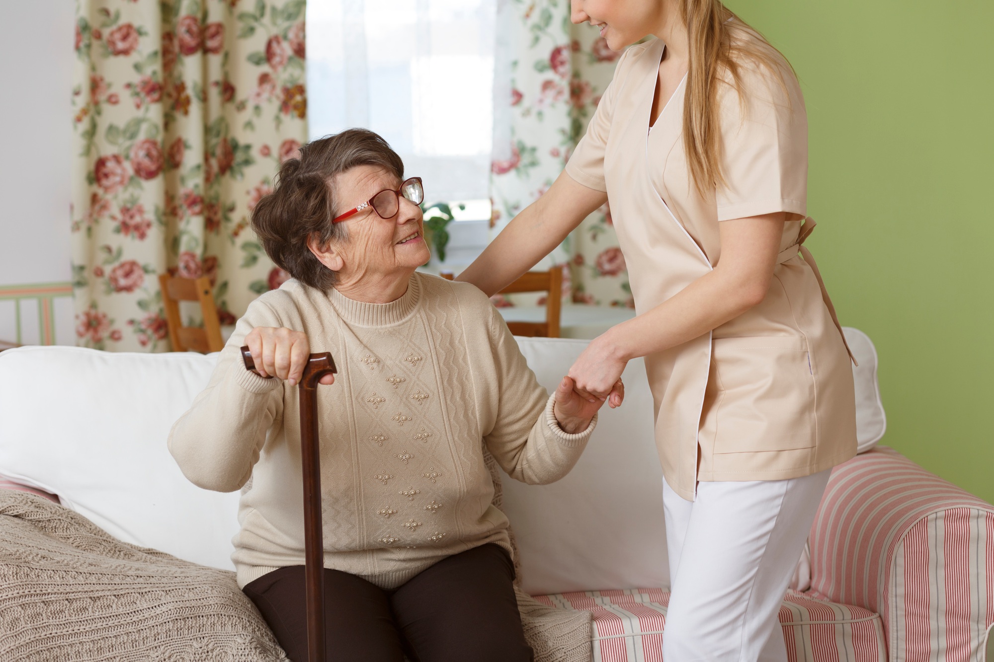 Caregiver helping senior woman